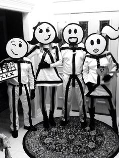 four people in costumes standing next to each other with faces drawn on their bodys