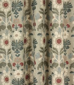 a close up view of a curtain with flowers and leaves on the fabric in grey