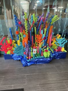 there are many different colored toothbrushes in the display case on the floor next to each other