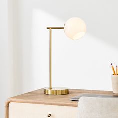 a desk lamp sitting on top of a wooden table