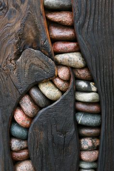 a close up of a wooden door with rocks and woodgrains on the side