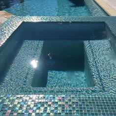 an empty swimming pool with clear blue water