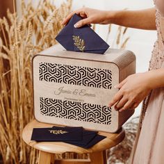 a person is holding a suitcase with an ornament on it and some napkins