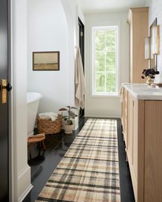 a bathroom with a rug on the floor