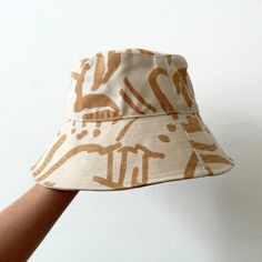 Perfect for a day of fun in the sun, our bucket hat is structured with an extra-wide brim to keep you cool and covered on the go. 100% cotton canvas screen printed with water-based inks Made in California Brim: 3.5" Circumference: 23" To clean: spot clean and/or dry clean. Summer Cotton Hat With Curved Brim, Casual Canvas Sun Hat With Wide Brim, Casual Wide Brim Sun Hat In Canvas, Casual Wide Brim Canvas Sun Hat, Cotton Bucket Hat With Short Brim For Beach, Cotton Hats With Graphic Print For Summer, Casual Canvas Bucket Hat With Curved Brim, Beige Summer Bucket Hat For Everyday, Beige Bucket Hat For Everyday Summer Use