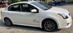 a white car parked in front of a building