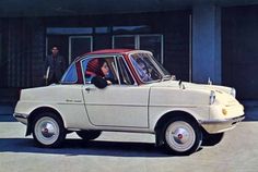 a woman sitting in the driver's seat of an old car