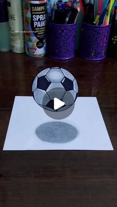 a soccer ball sitting on top of a piece of paper