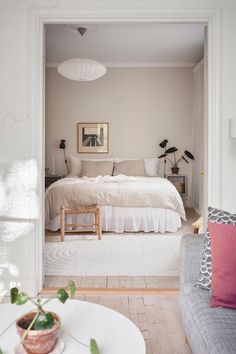 an open door leading to a bedroom with a bed and couch