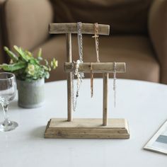 a white table topped with a vase filled with flowers and chains hanging from it's sides