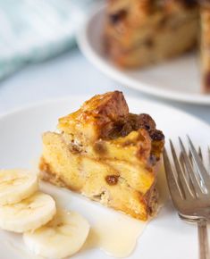 a piece of cake on a plate with bananas