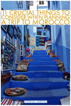 an alleyway with blue steps and pictures on the wall, in morocco text reads 11 crucial things to consider when planning trip to morocco