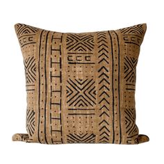 a brown and black pillow with an intricate design on the front, sitting on a white background