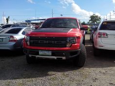 two trucks parked next to each other in a parking lot