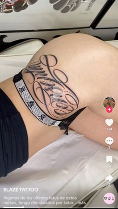 a woman laying on top of a bed with her stomach covered in tattoos and writing