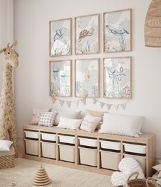 a room with several pictures on the wall and stuffed animals in baskets next to it