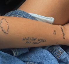 a woman's arm with writing on it that says, worship while you wait