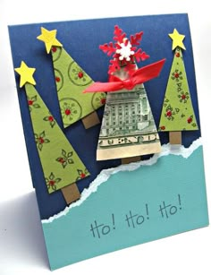 an origami christmas card with trees and money