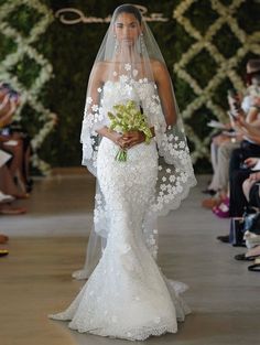 a woman in a white wedding dress and veil