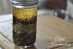 a jar filled with tea sitting on top of a wooden table