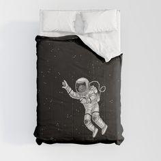 an astronaut is flying through the sky on a black and white comforter