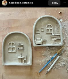 two clay molds sitting on top of a wooden table