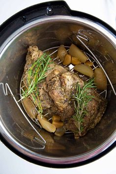 the meat is cooked and ready to be eaten in the pressure cooker with rosemary sprigs on top