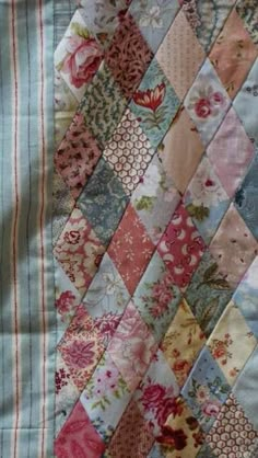 an old quilt with many different colors and patterns