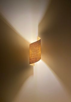 a lamp that is on the wall with a light coming from it's side