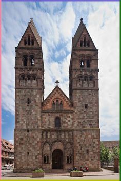 an old stone church with two towers