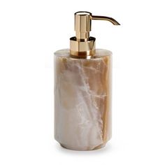 the soap dispenser is made out of marble and has a gold faucet