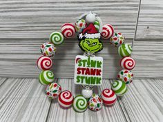 a christmas wreath made out of candy canes with a sign that says stink stank stink