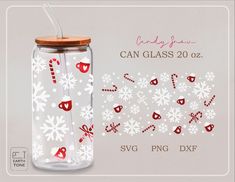 a glass jar filled with candy canes and snowflakes next to a white background