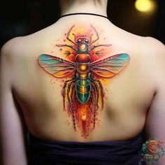 the back of a woman's neck with a colorful bee tattoo on her chest