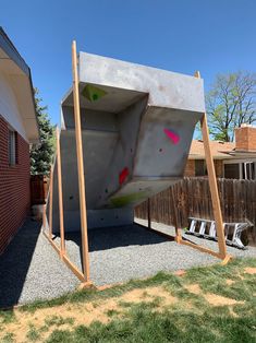 an outdoor climbing wall in the back yard