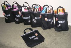 a group of black bags sitting on top of a carpeted floor next to a wall