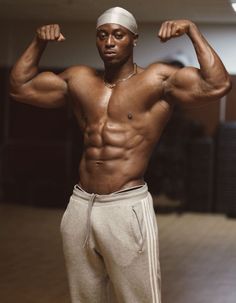 a man flexing his muscles in the gym