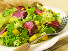 a white plate topped with meat and veggies