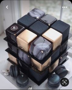 a stack of black and gold cubes sitting on top of each other