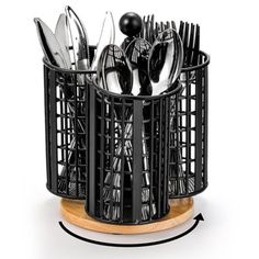 a black basket filled with silverware on top of a wooden stand