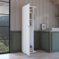 a tall white cabinet sitting next to a window