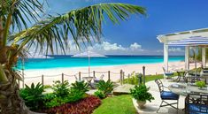 an outdoor dining area overlooking the beach and ocean