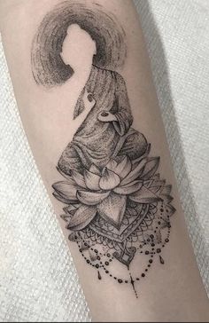 a woman's arm with a tattoo on it and a flower in the middle