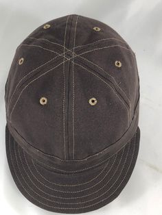 The mechanics cap is a symbol of the Industrial Age of the early 20th century. Keeping true to tradition, this cap is handcrafted using top-notch materials that would have been found on turn of the century headwear. The front has no stiffener and the cap is made with a short flexible visor, and the hat itself is made with 100% brushed cotton canvas and a cotton sweatband. Prefer another fabric or different type of sweatband? Just ask, we love custom orders. Adjustable Brown Canvas Baseball Cap, Brown Canvas Baseball Cap, Brown Flat Bill Cotton Hats, Brown Cotton Six-panel Baseball Cap, Vintage Brown Cotton Baseball Cap, Brown Cotton Fitted Hat With Curved Brim, Brown Cotton Fitted Cap, Brown Cotton Cap, Vintage Canvas Baseball Cap