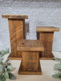 two wooden stools sitting next to each other