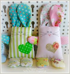 several stuffed animals are lined up against a wall with polka dots and hearts on them