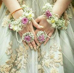 a close up of a person wearing flowers in their hands