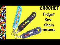 the crochet fidget key chain is made with beads and chains that are different colors