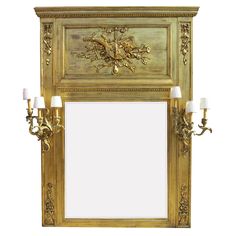 an ornate gold framed mirror with candles