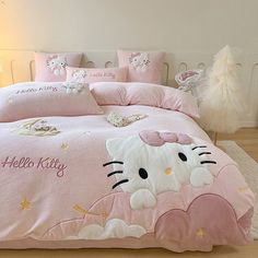 a hello kitty bed set with pink sheets and pillows